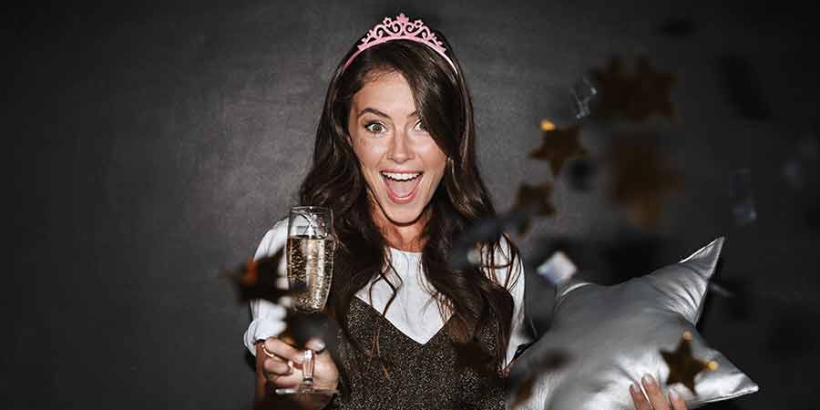 Image of social media influencer, crown, champagne, star pillow